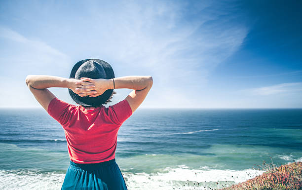 Young woman looking out over the ocean.
