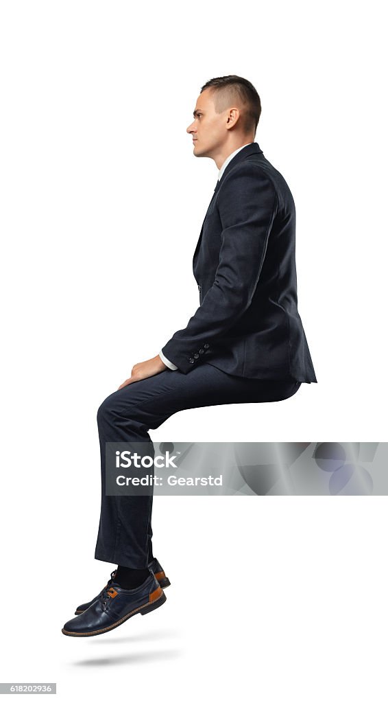 Businessman in profile in sitting position isolated on the white A businessman in profile in sitting position isolated on the white background. Business and management. Poses and gestures. Sitting Stock Photo