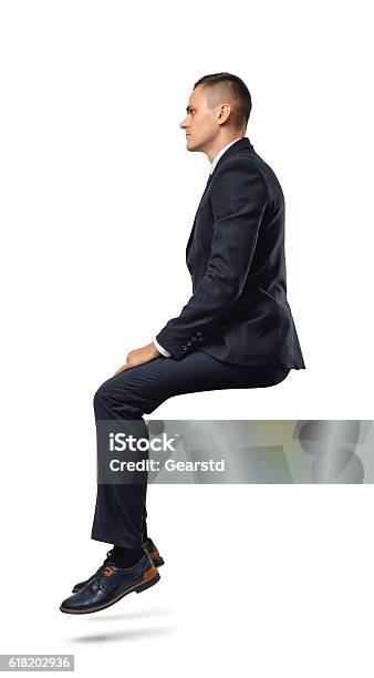 Businessman In Profile In Sitting Position Isolated On The White Stock Photo - Download Image Now