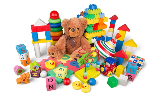 A baby is playing with a wooden toy block