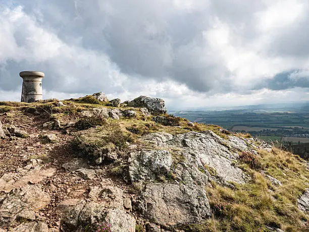 Trig point atop one of the Eildon Hills in the Borders region of Scotland, seen from a hillwalker's perspective.