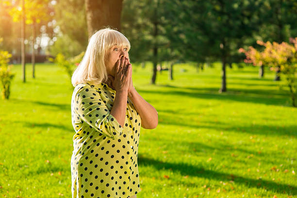 istock Female covers mouth with hands. 618205762