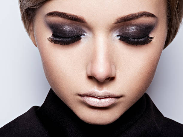 istock Woman with black eye makeup 618206616