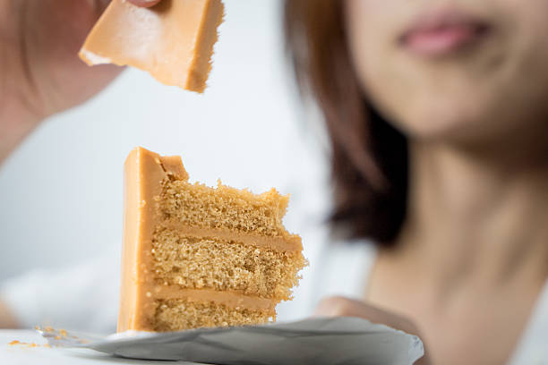 Japanese girl having cake using her finger.