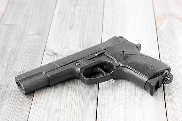 istock Air gun on a wooden table. 618207642