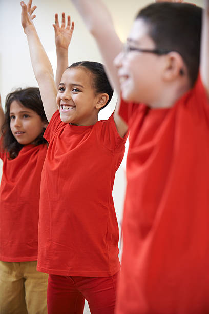 istock Group Of Children Enjoying Drama Class Together 618208384