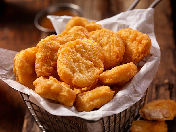 Basket of Chicken Nuggets with Sweet and Sour Sauce Basket of Chicken Nuggets-Photographed on Hasselblad H3D2-39mb Camera deep fried photos stock pictures, royalty-free photos & images