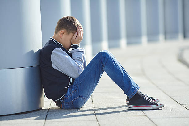 istock little boy crying on the street 618209960