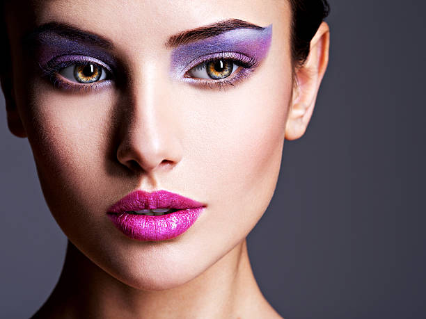 istock Beautiful  face with purple eye make-up 618210296