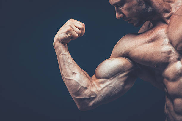 istock The athlete shows his beautiful body on black background. 618210548