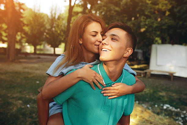 istock man carries a girl on his back 618212038