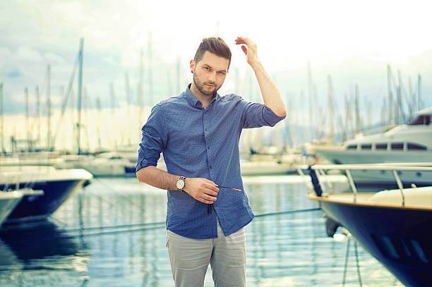 istock Handsome man with luxury yachts in port. 618212148