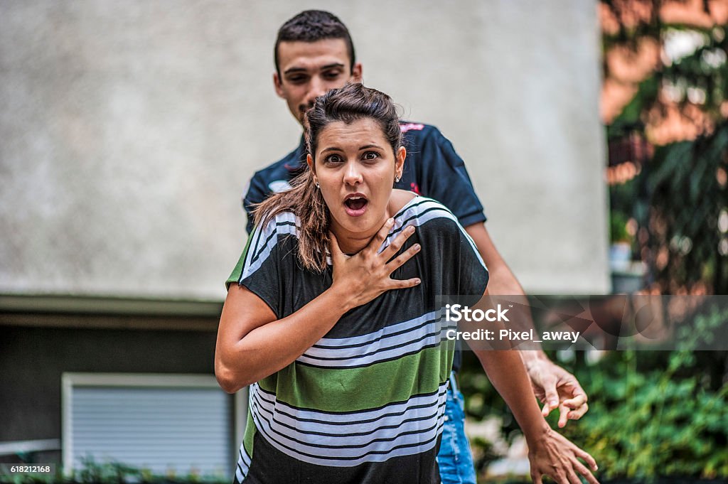 Girl needing help A girl is in danger Choking Stock Photo