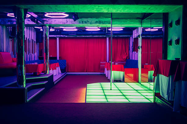 Night club interior with pole dance stage Night club interior with pole dance stage with neon lights no people exotic dancers pics stock pictures, royalty-free photos & images