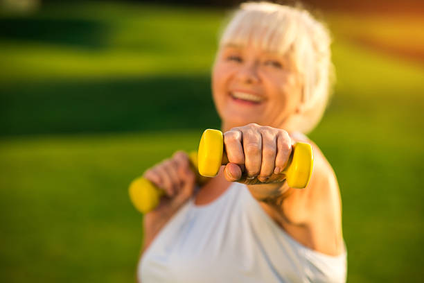 istock Senior woman holding dumbbell. 618213356