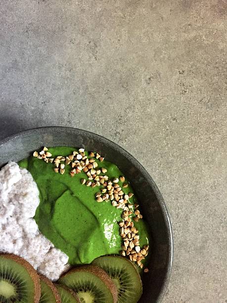 Green smoothie and coconut chia pudding bowl with buckwheat, kiwifruit