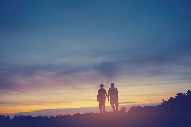 istock Couple on background of sunset. 618217336