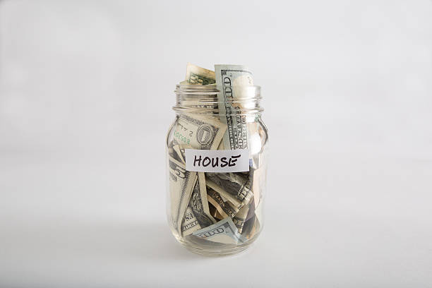 istock Mason jar with money for House 618218234