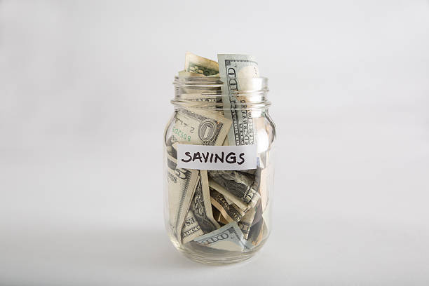 istock Mason jar with money for savings 618218452