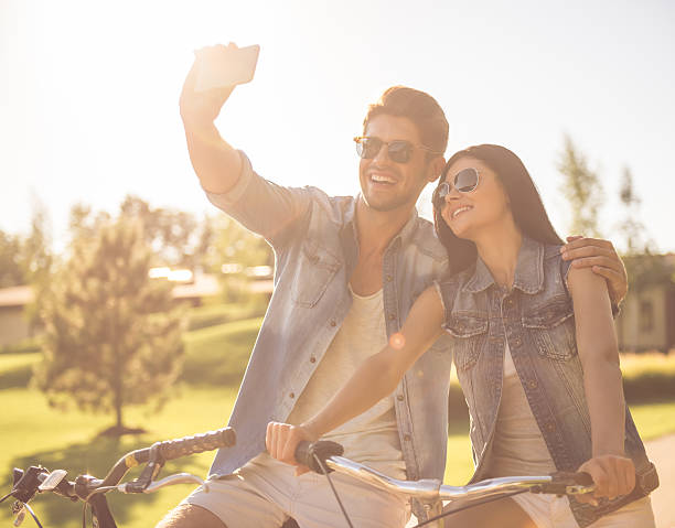 istock Couple cycling in park 618219100