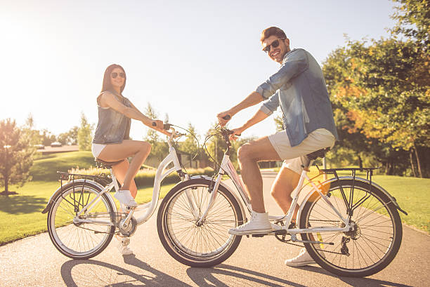 istock Couple cycling in park 618219162