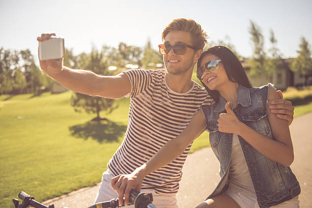istock Couple cycling in park 618220152