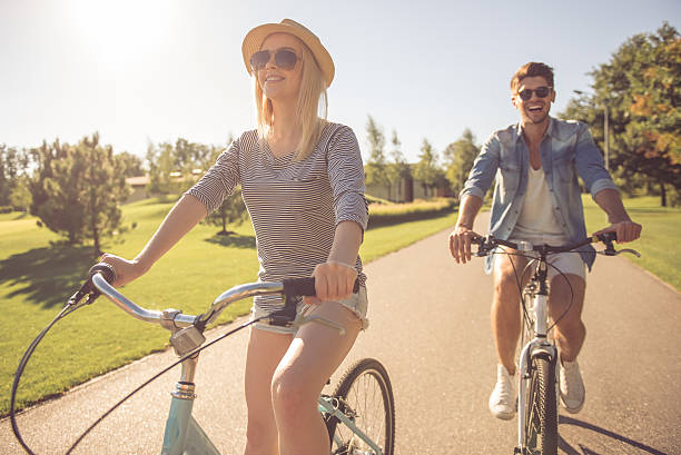 istock Couple cycling in park 618220400