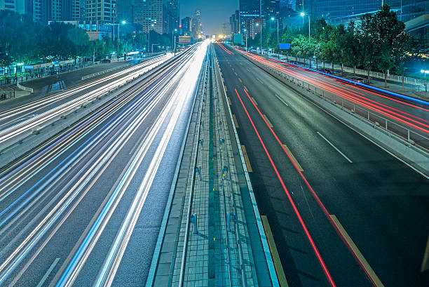 istock blurred traffic light trails on road at night 618220922