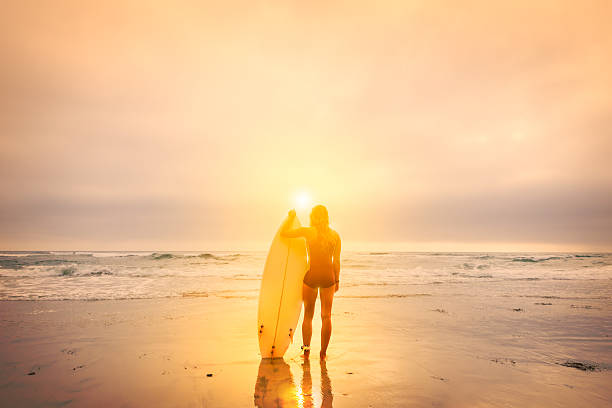 istock Women Surfer At Sunset 618222712