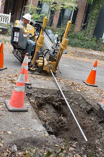 Angled View, Pipeline Worker Operating Horizontal Directional Drill stock photo
