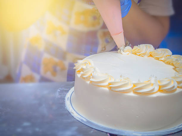 istock close up women decorate cake 618224646