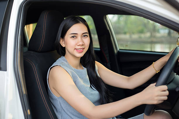istock Cute young lady happy driving car 618315648
