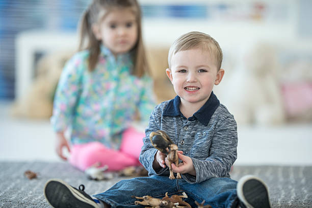 istock Little Boy Happily Playing in Class 618317960