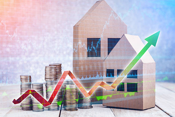 istock paper house and stacks of coins standing 618318426
