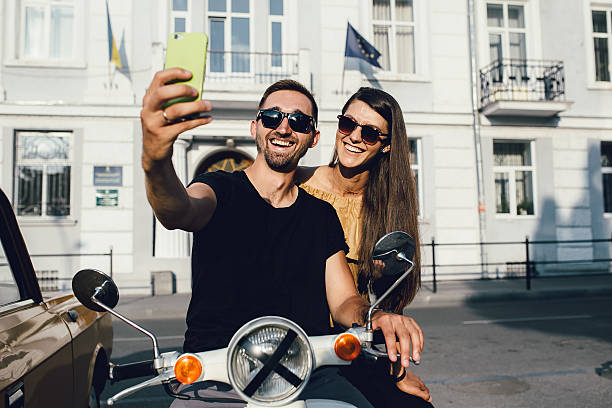 istock Cute couple make selfie on a scooter 618318696