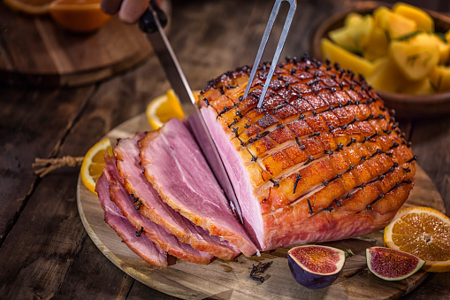 Carving Delicous Glazed Holiday Ham with Cloves