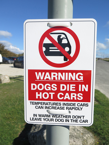 Sign in car park warning of dogs overheating in cars