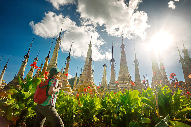 istock Woman traveling with backpack looking at stupa Buddhist temple 618320224