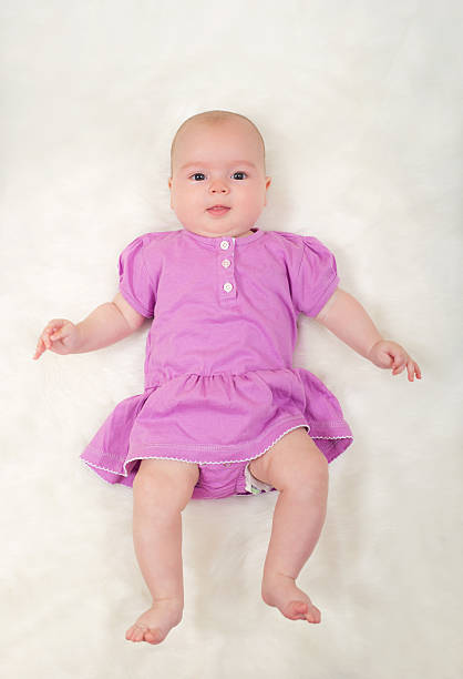 istock Cute baby girl lying on her back 618320924