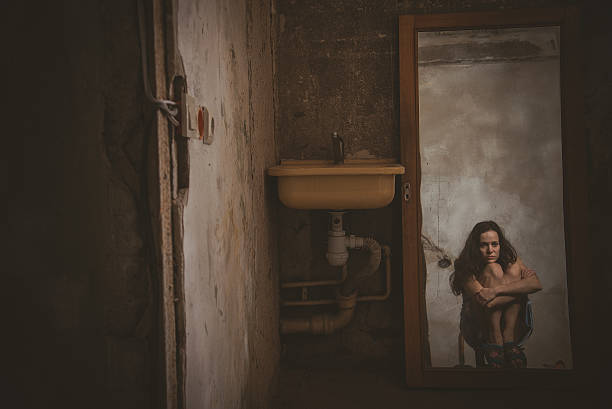 istock Cheap accommodation. The girl looks into the old distorted mirro 618321500