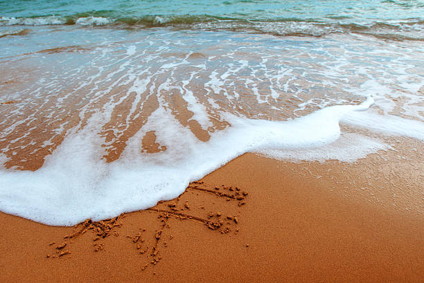 istock Figures in the sand on the beach. 618325076