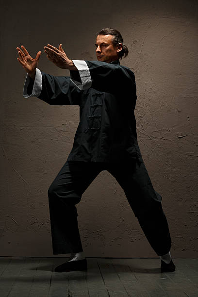 istock Practicing Tai Chi    Man in kimono excercising martial arts 618328506
