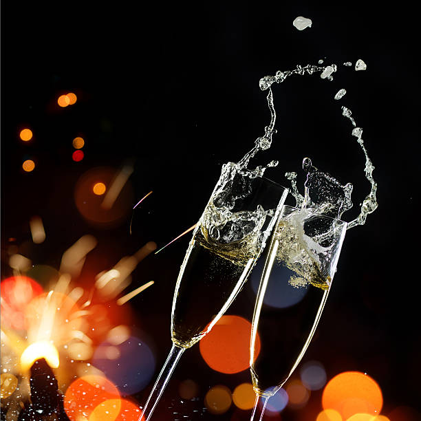 istock Champagne Glasses With Sparkler And Defocused Lights 618329026