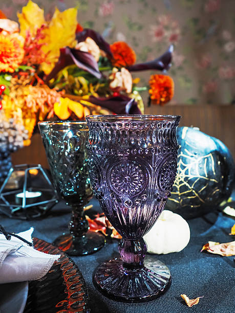 Table served in Halloween style. Gothic glasses on black tablecloth