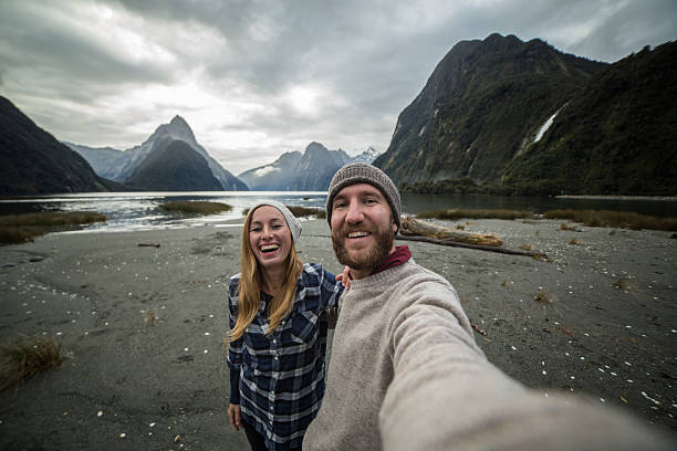 istock Caucasian couple take selfie portrait with mountain landscape 618330106