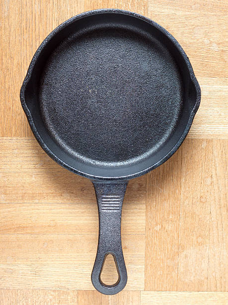 istock Cast iron skillet on wooden table 618331446