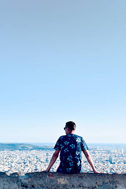 istock young man with the city bellow him 618331636