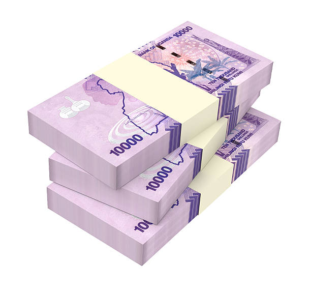 istock Ugandan shillings bills isolated on white background. 618332364