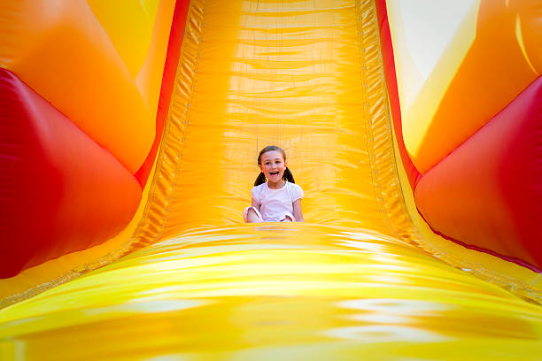 chica en diapositiva - inflatable child playground leisure games fotografías e imágenes de stock