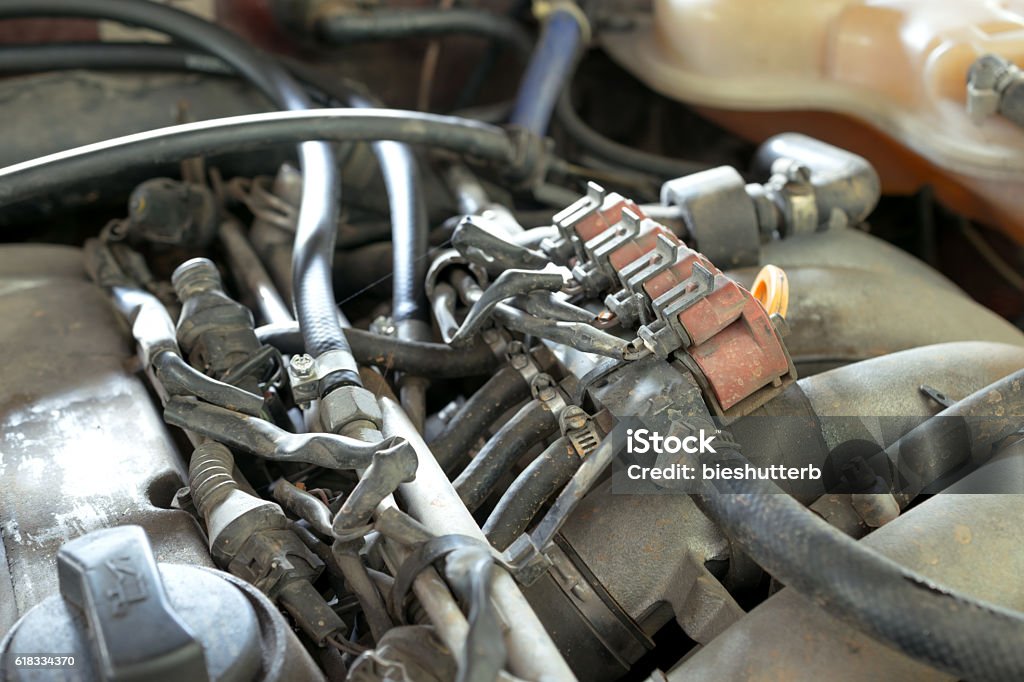 lpg car injectors in old car engine need to service, lpg car injectors in old car engine need to service, gas injector installed in gasoline engine to use cheaper alternative fuel. Car Stock Photo